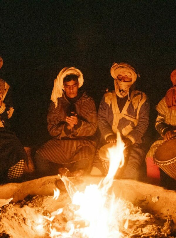 group of people sitting on chair in front of bonfire
