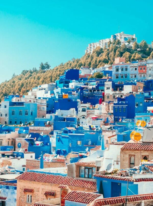 blue and white painted houses on the cliff
